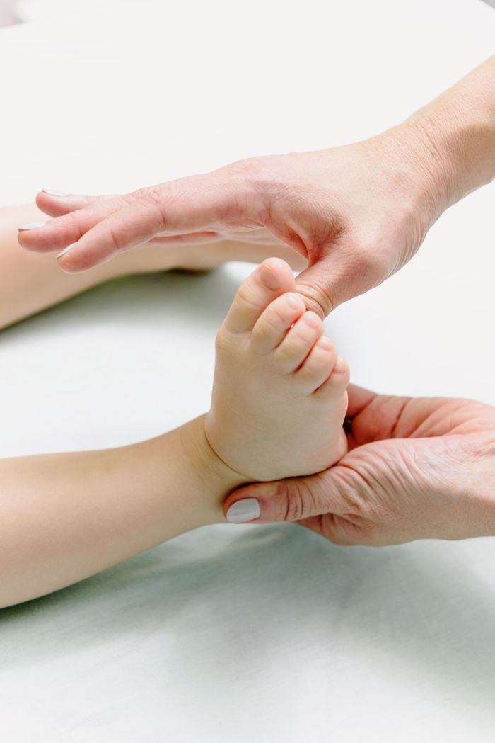 Services 8 Tender close-up capturing hands massaging a baby's foot, symbolizing relaxation and care.